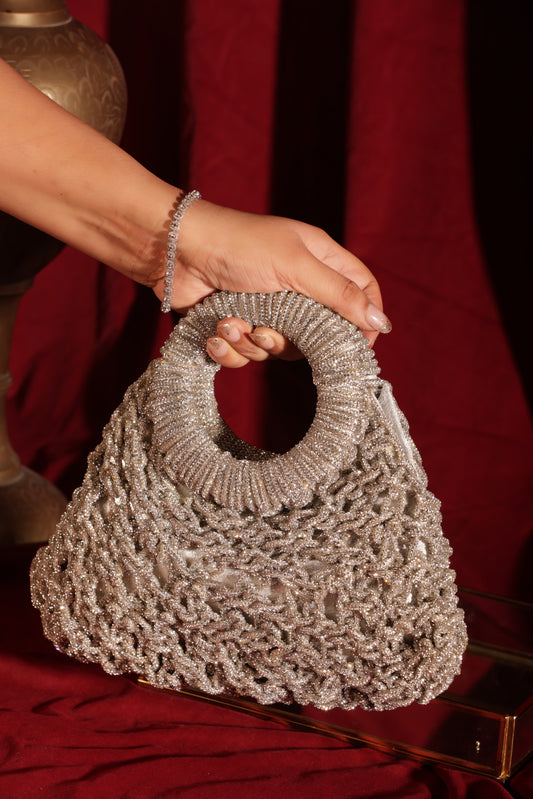 Luxury mesh-work crescent handbags in multiple colors with circular handles, perfect for weddings and festive styling.