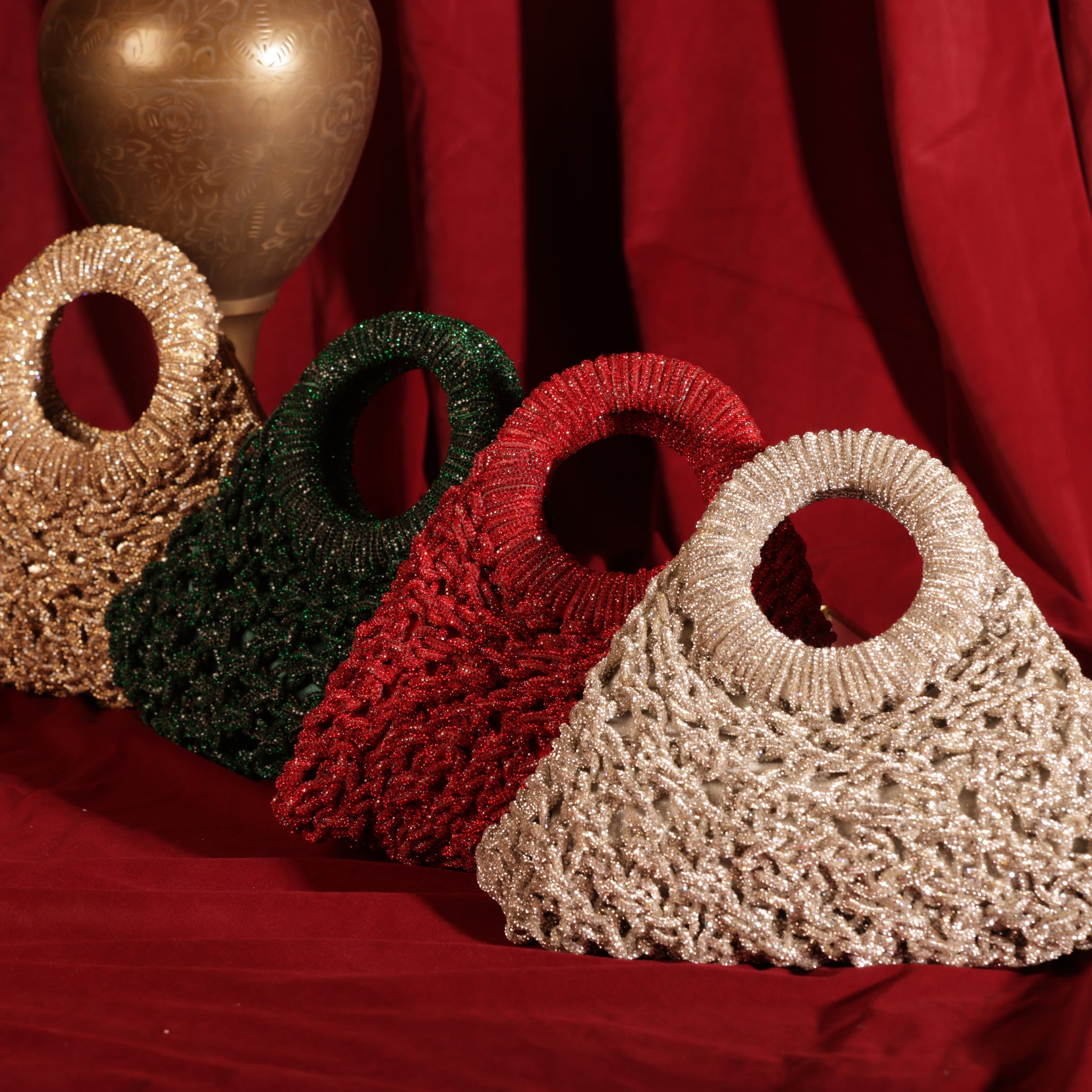 Luxury mesh-work crescent handbags in multiple colors with circular handles, perfect for weddings and festive styling.