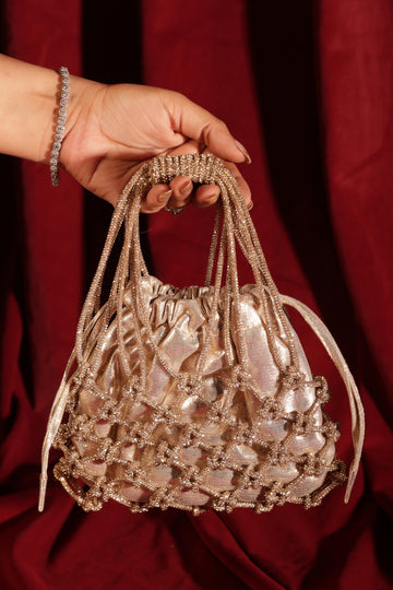 Golden potli bag with beaded net overlay and metallic shimmer finish, front view.