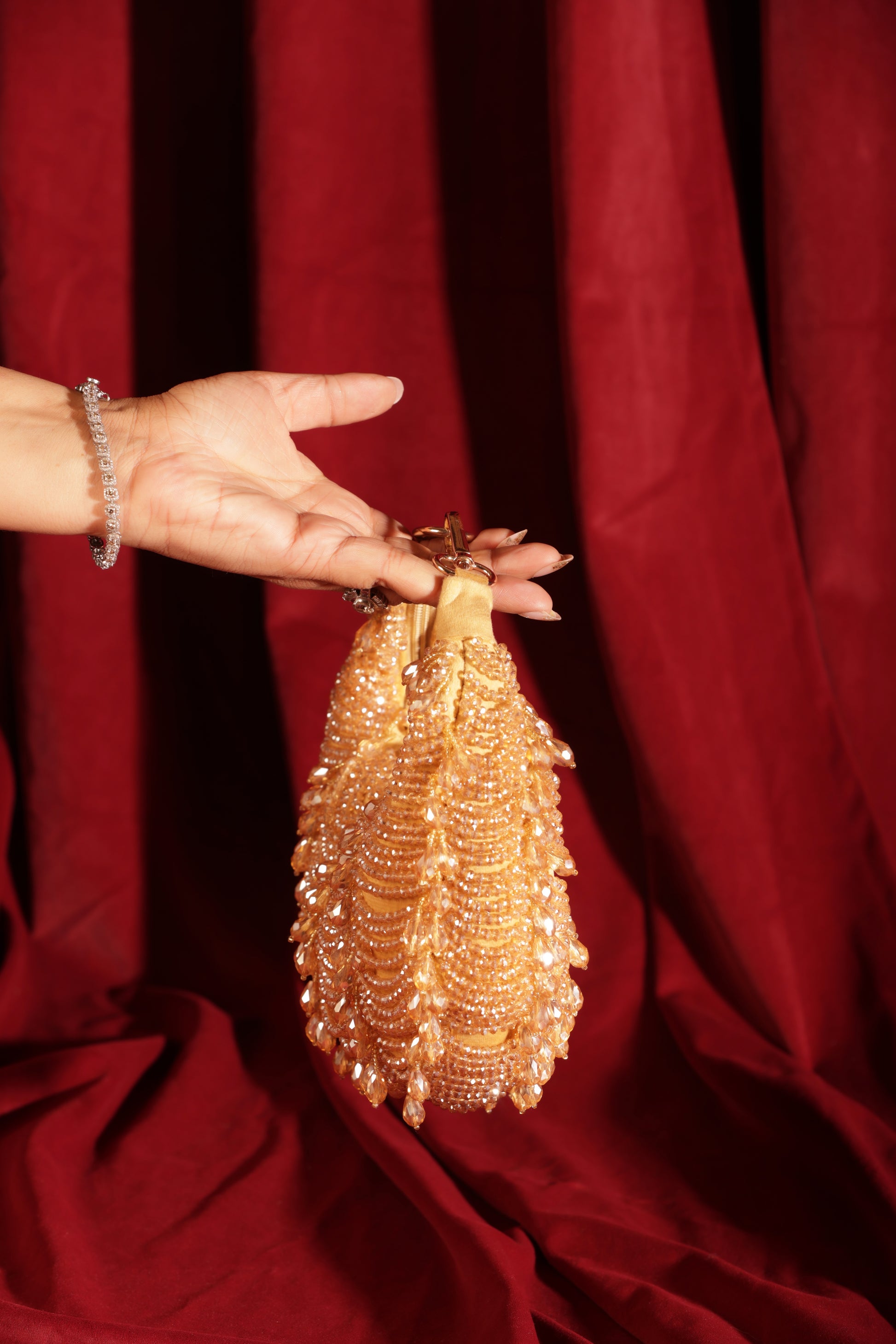 Crystal-studded gold crescent bag perfect for weddings, sangeet nights, receptions, and evening events.
