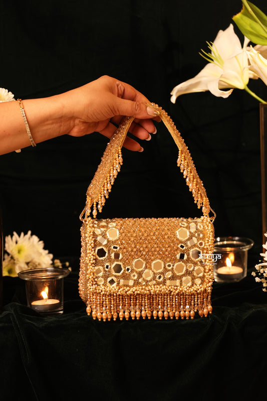 Model styling an artisanal Indian mirror embellished evening bag for festive Diwali outfits