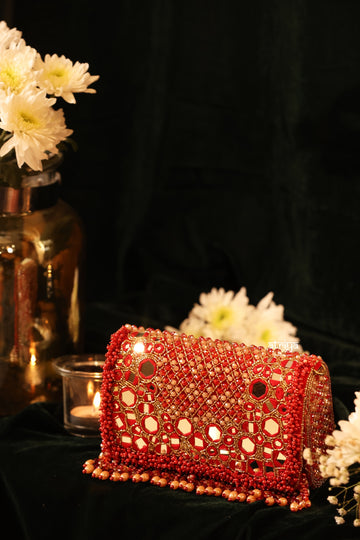 Handcrafted red Rajasthani mirror work clutch and luxury beaded party bag by Atriya Jaipur