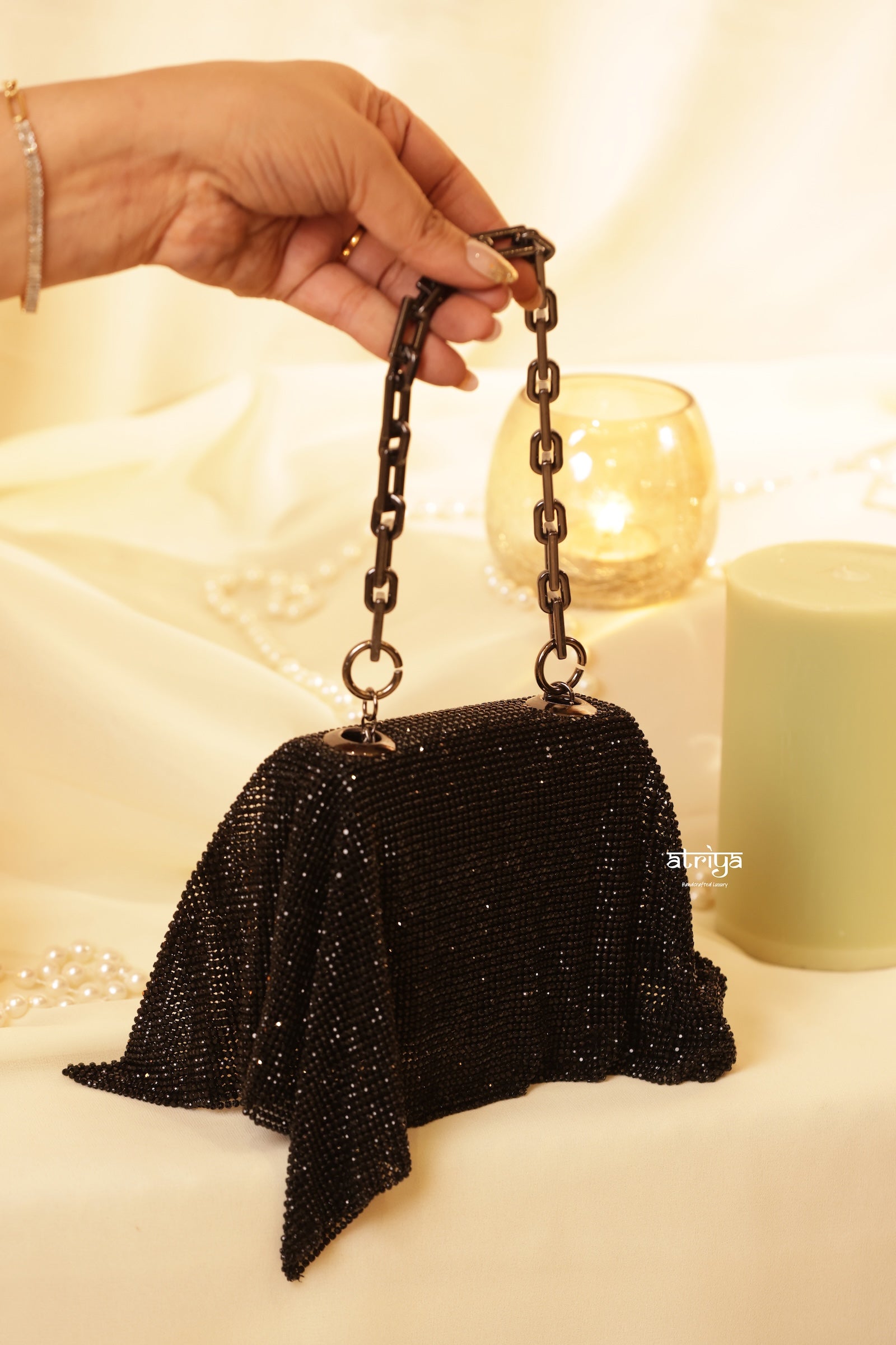 Close-up of black crystal mesh detailing on handcrafted luxury clutch bag for weddings and parties