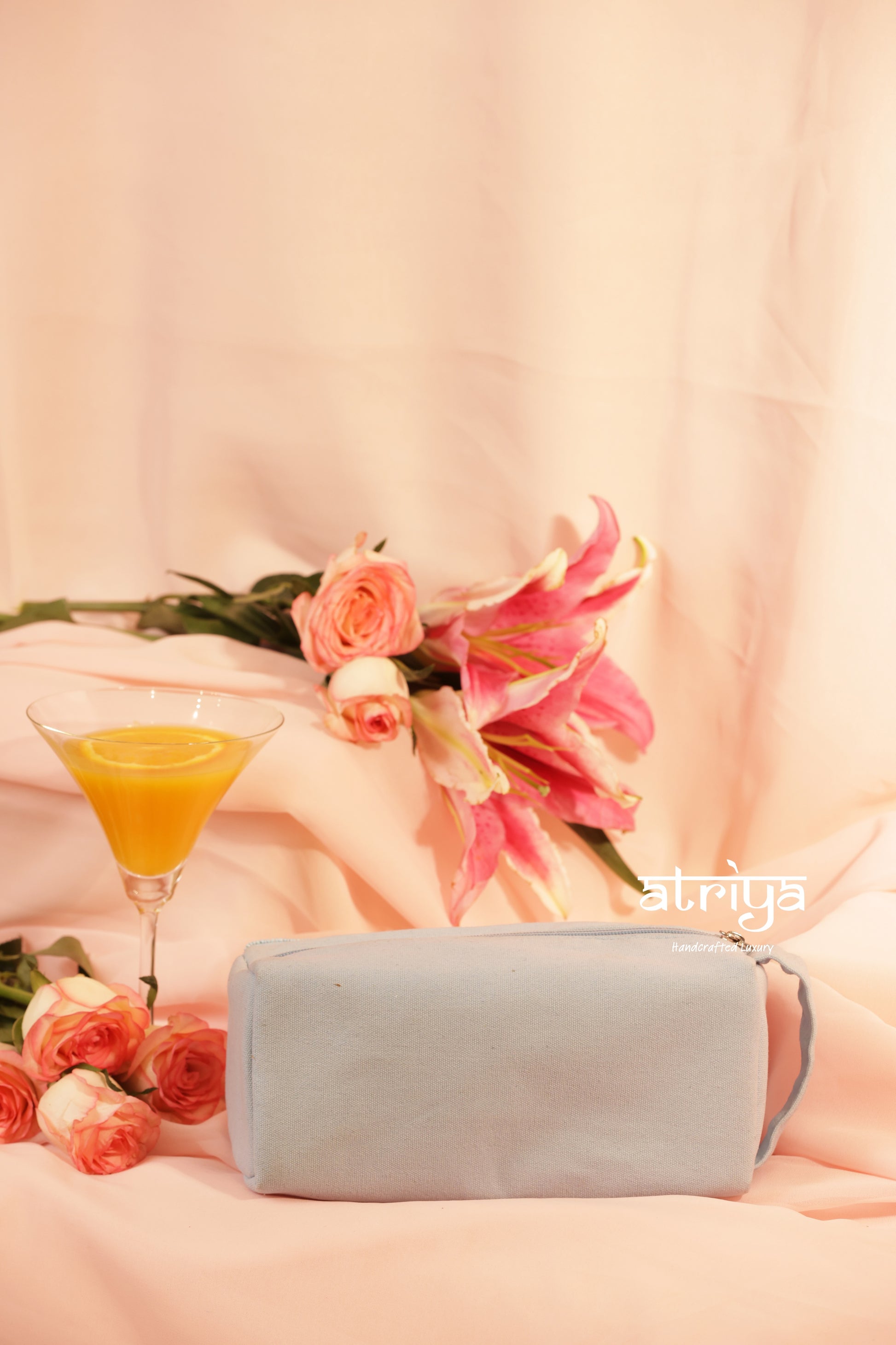 Structured handcrafted hair organiser bag in pastel blue with dense beadwork and rose gold embroidery, editorial product photography for Atriya Jaipur collection.

