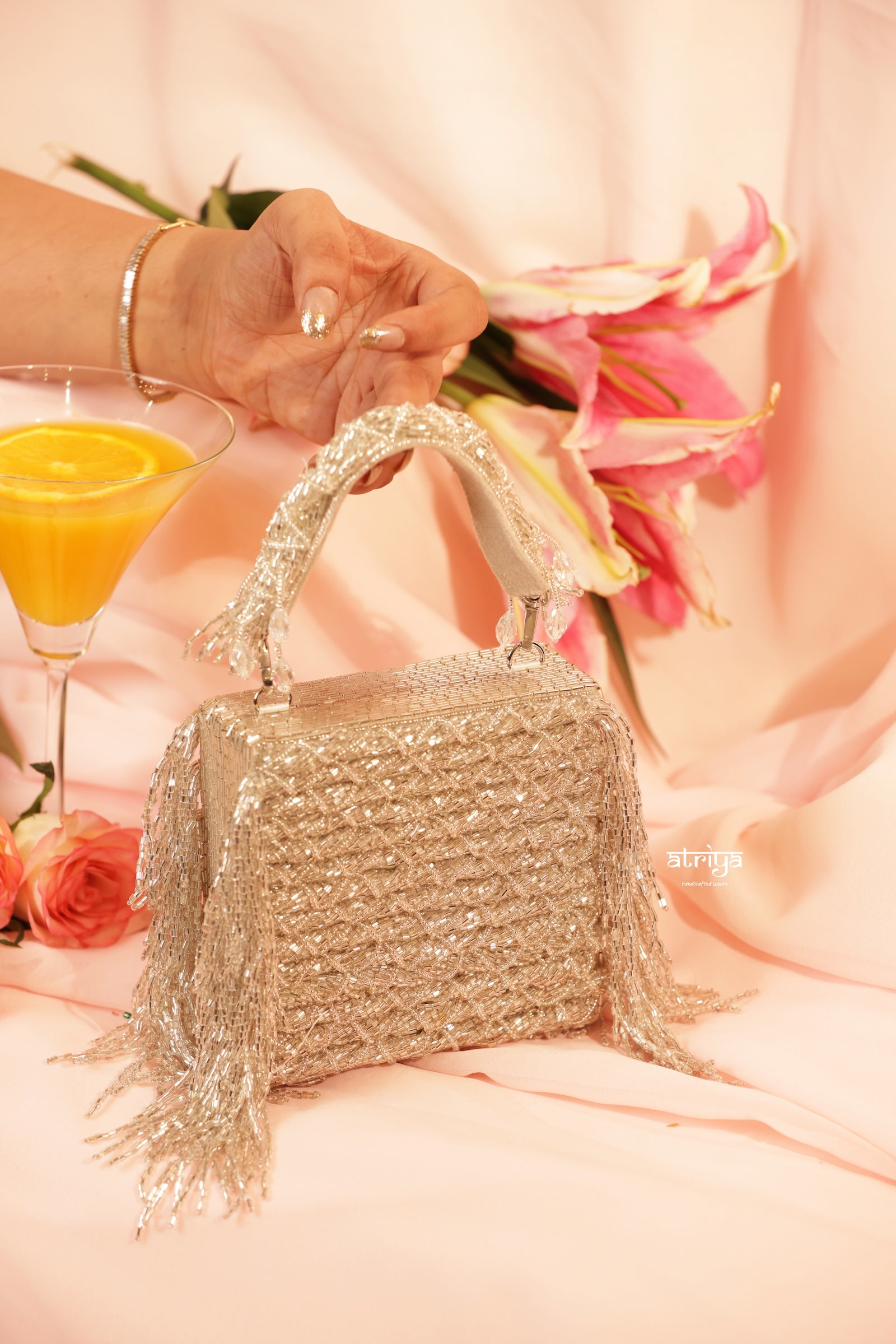 Model holding the Atriya Jaipur Inayat pure silver crystal clutch with festive evening attire