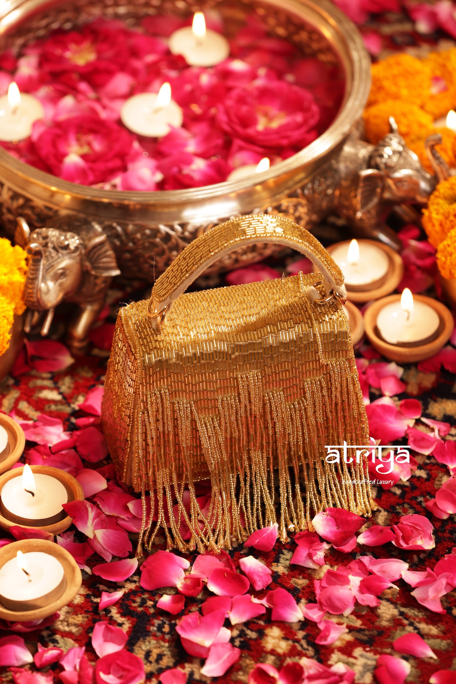 Tarana Gold beaded handbag displayed amidst festive candles and rose petals