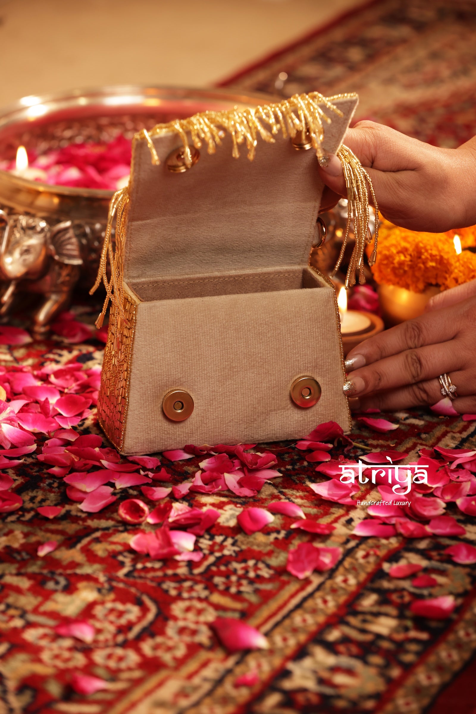 Close up of hand-sewn gold bugle beads and dense tassel fringe on Tarana Gold bag
