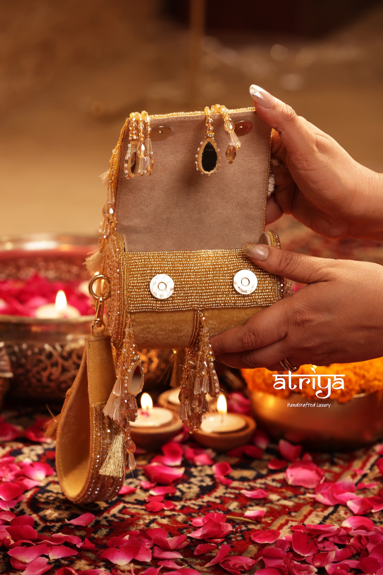 Close up of teardrop mirrors, cascading crystal strands, and metallic tassels on Noorani Gold structured bag