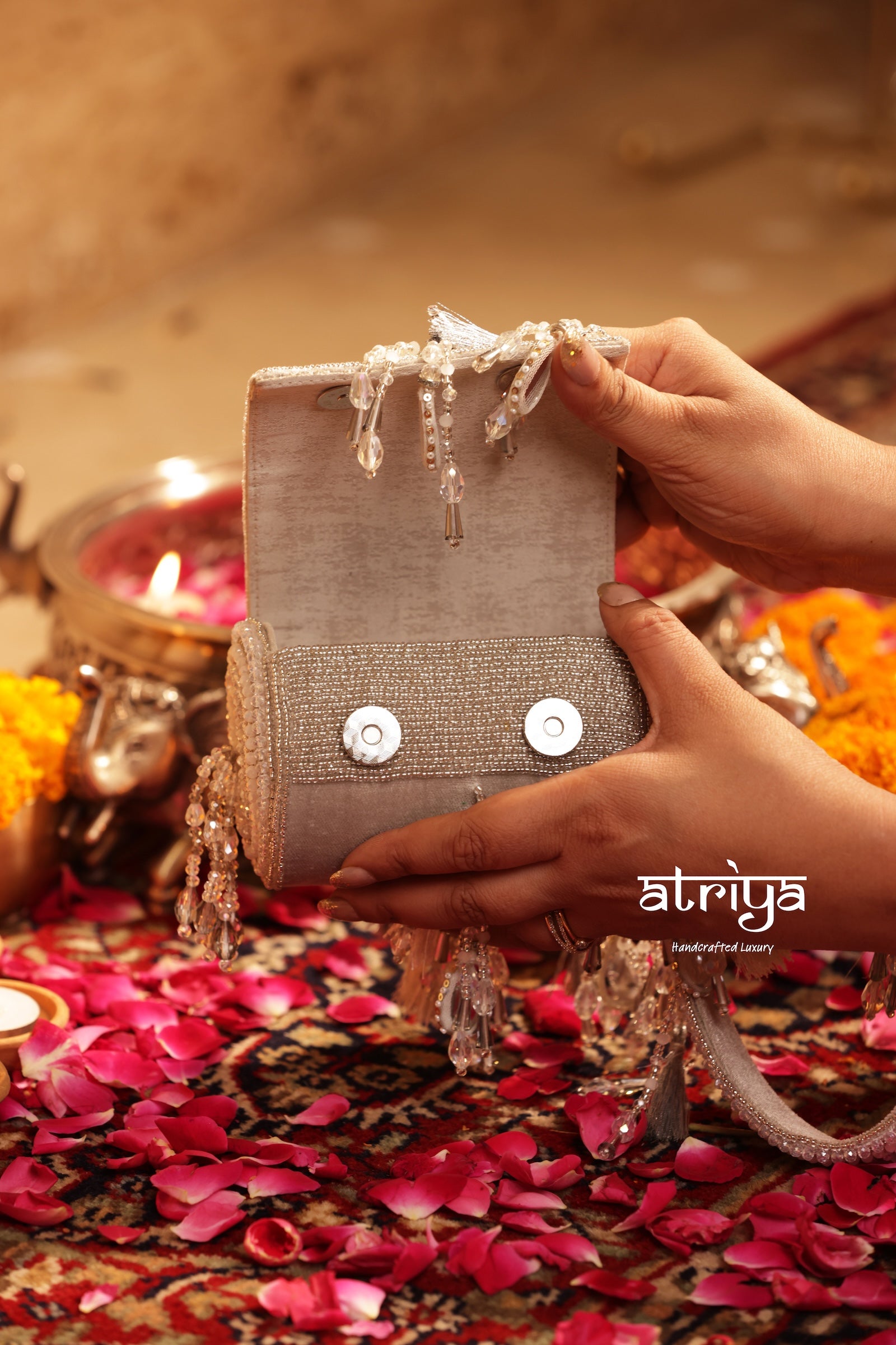 Atriya Noorani Silver handcrafted mirrorwork and tassel fringe cylindrical clutch held by hand strap